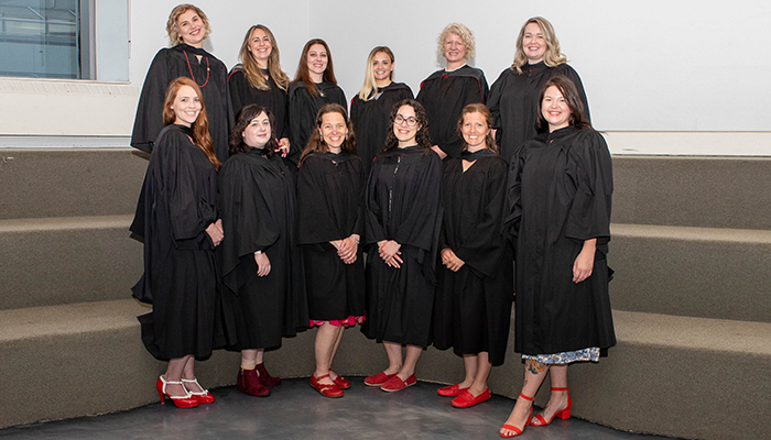 Midwifery Winnipeg graduation showing graduates posing with gowns and red shoes